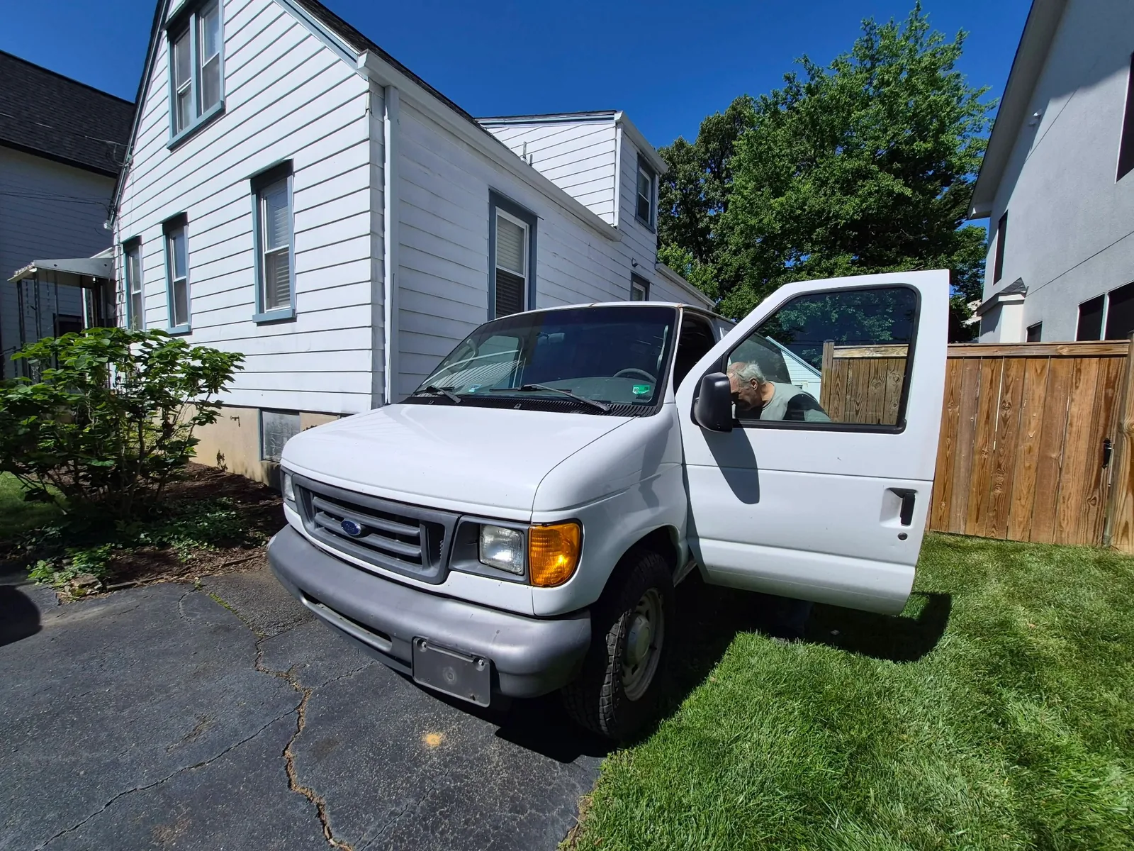 Cash for cars pickup of a Ford van in a residential driveway in Arlington, VA by Dalo Auto Recycling