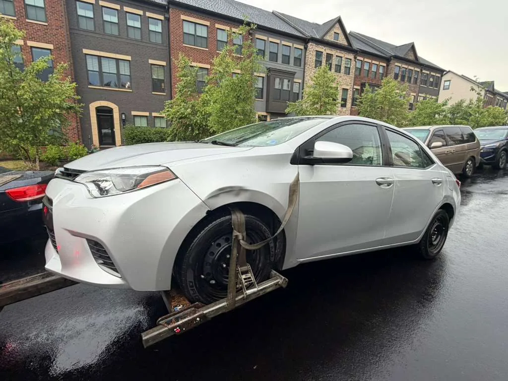 Sedan loaded for cash-for-cars pickup in an Arlington, VA townhome neighborhood by Dalo Auto Recycling