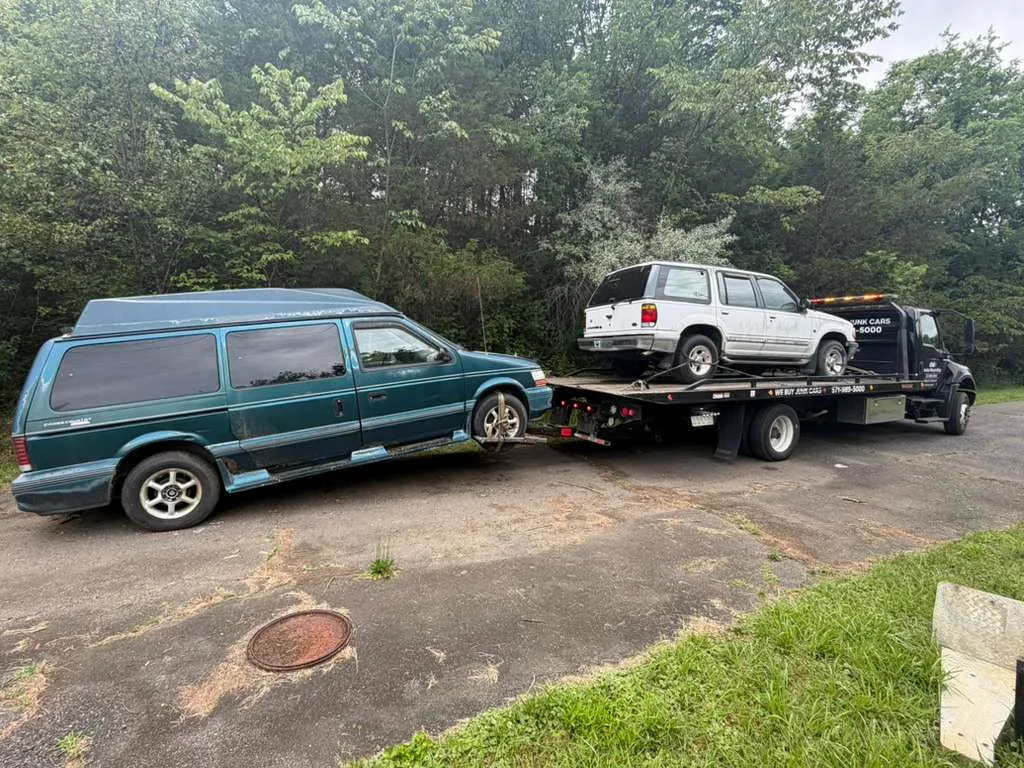 Two vehicles loaded on a Dalo Auto Recycling flatbed in Northern Virginia