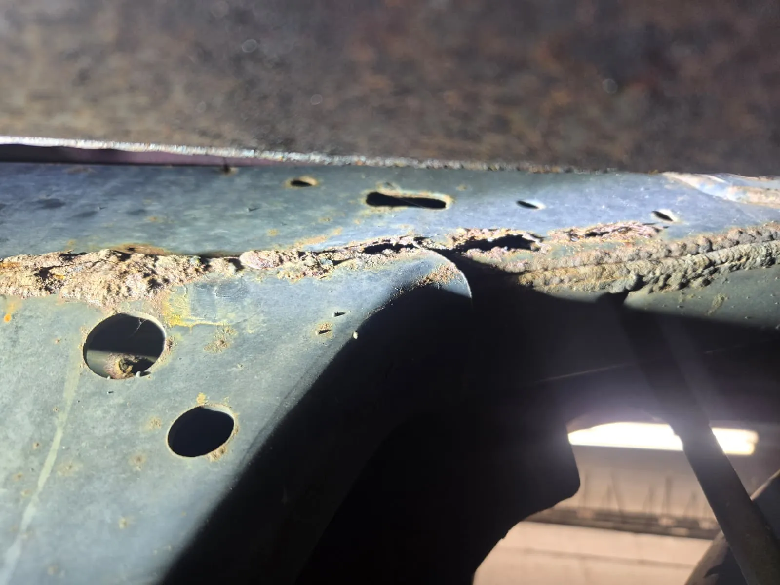 Heavy frame corrosion on an older Toyota truck failing Virginia safety inspection