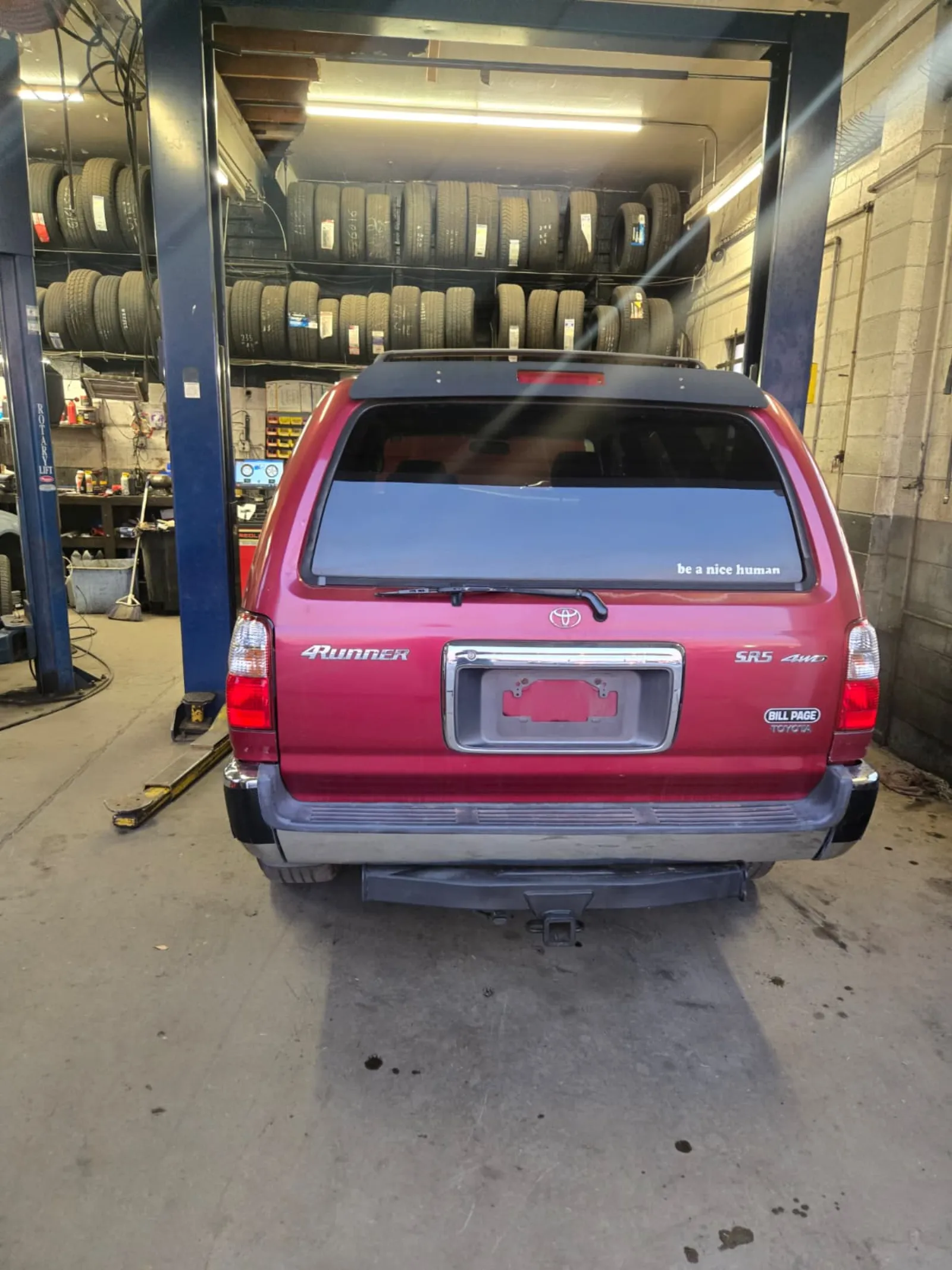 Red Toyota 4Runner inside a Northern Virginia shop being evaluated for repair