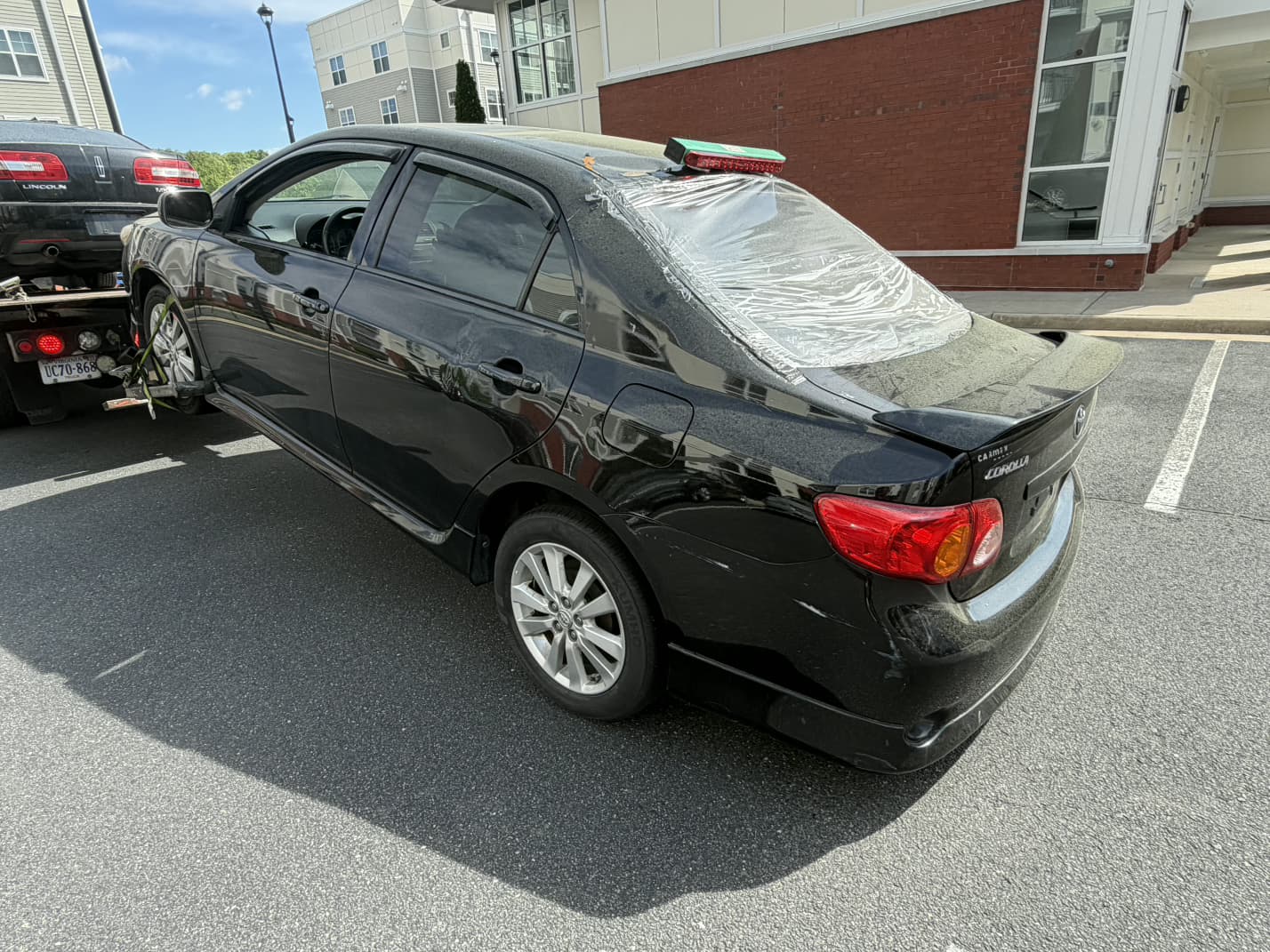 Toyota Corolla being loaded from a condo and shared parking area in Reston, VA