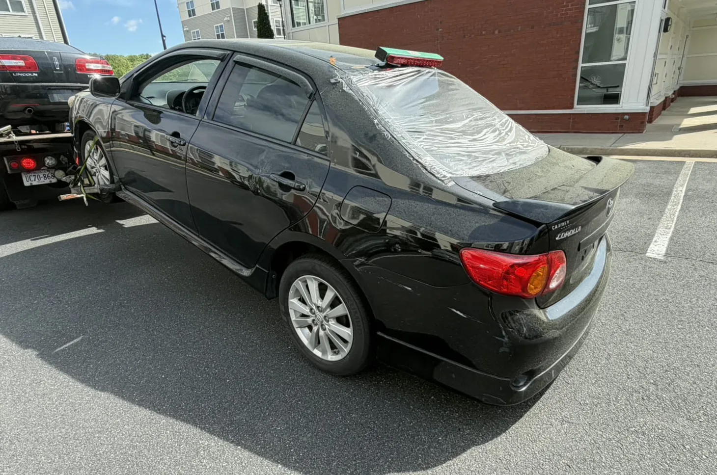 Toyota Corolla being picked up from an apartment parking area in Richmond, VA